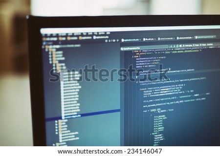 Web site codes on computer monitor. developer working on web sites codes in office.