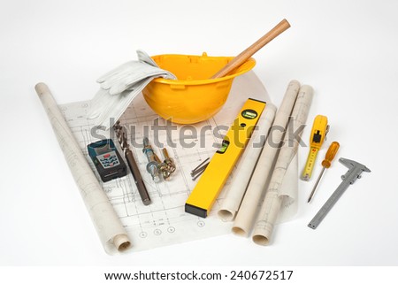 group of construction tools and old blueprints