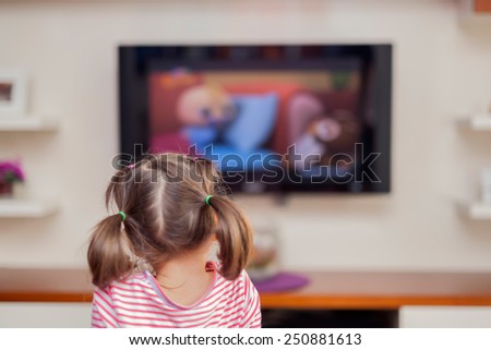 little cute girl watching tv