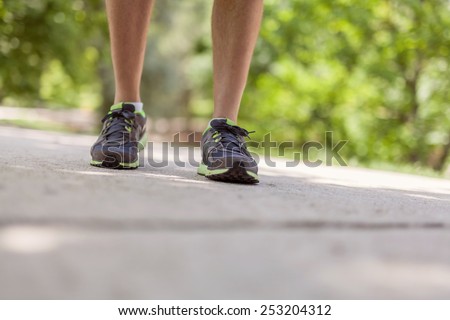 Closeup walking feet outdoors. Fitness, jogging, healthy lifestyle concept.