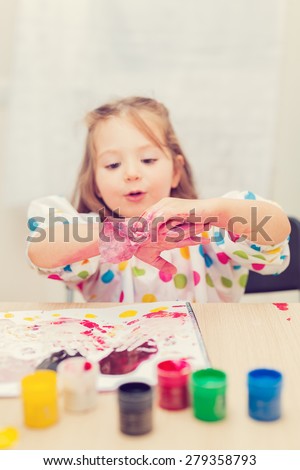 cute little girl finger painting