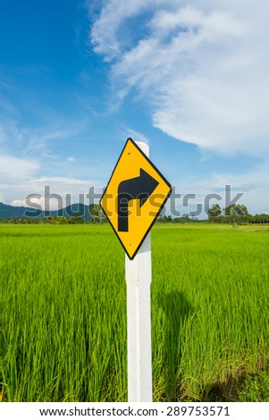 Rice fields with right turn sign