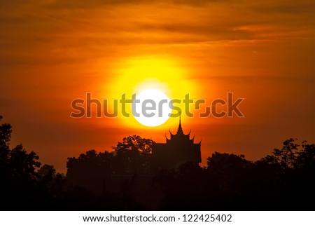 After sunrise. Silhouette of temple on the background of the rising sun.