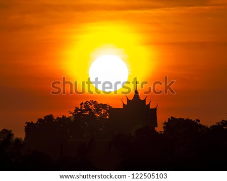Silhouette of temple on the background of the rising sun.
