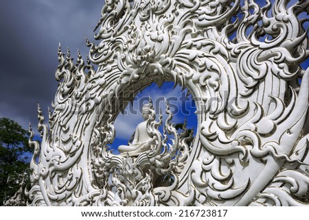 Sitting Buddha of White Temple. Contemporary unconventional Buddhist temple in Chiang Rai, Thailand