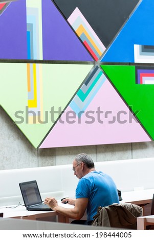 RUZOMBEROK, SLOVAKIA - MAY 12 2014: A man in study hall at university