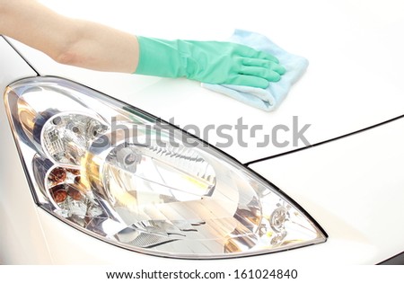 Hand of woman cleaning car using microfiber cloth