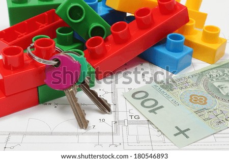 Closeup of home keys, heap of colorful building blocks and banknote lying on construction drawing of house, building blocks for children, housing plan with building blocks, finance concept