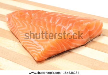 Closeup of salmon steak, portion of salmon steak, portion of fish. Wooden background
