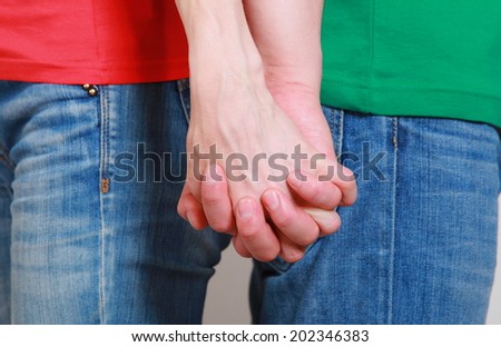 Hands of man and woman in handshake, couple holding hands