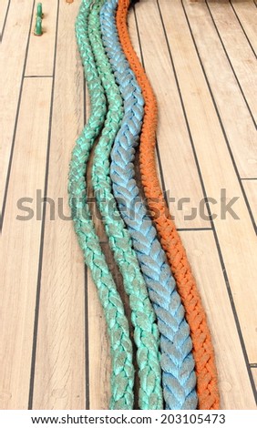 Yachting. Nautical thick ropes, nautical colorful thick cord lying on deck of yacht, rigging details on old sailboat