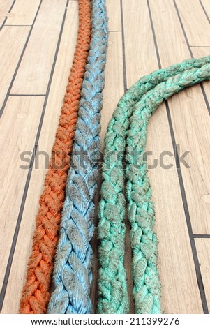 Yachting. Nautical thick ropes, nautical colorful thick cord lying on deck of yacht, rigging details on old sailboat