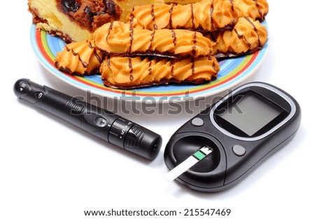 Fresh baked pastry and cakes on colorful plate and glucose meter, concept for diabetes and glucose level test. Isolated on white background