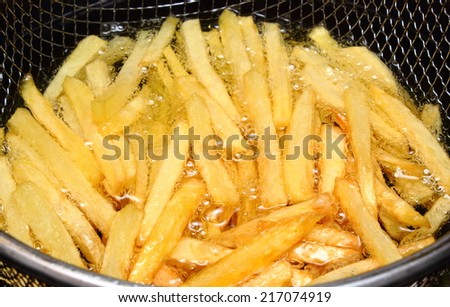 Heap of french fries fried in oil, deep fried, unhealthy and caloric food