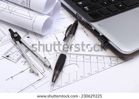 Rolls of electrical diagrams, construction drawings of house, accessories for drawing and laptop, drawings and accessories for the projects engineer jobs
