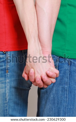 Hands of man and woman in handshake, couple holding hands
