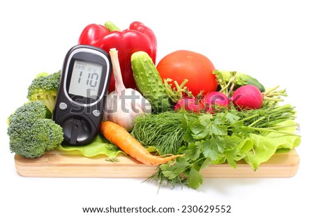 Glucose meter and fresh ripe raw vegetables lying on wooden cutting board, desk of healthy organic vegetables, concept for healthy eating and diabetes. Isolated on white background