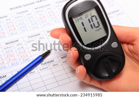 Hand of woman with glucose meter and medical form with results of measurement of sugar, concept for measuring sugar level