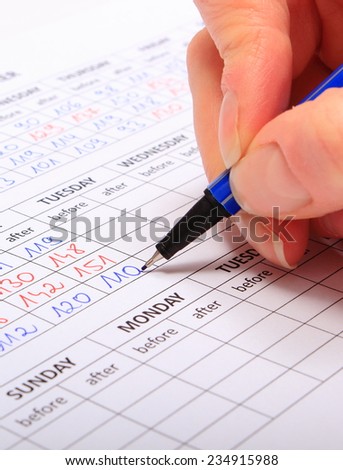 Hand of woman writing to medical form result of measurement sugar, concept for measuring sugar level
