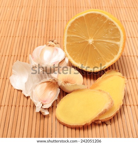 Garlic, lemon and ginger on wooden background, fresh and healthy food products, concept for healthy nutrition and health