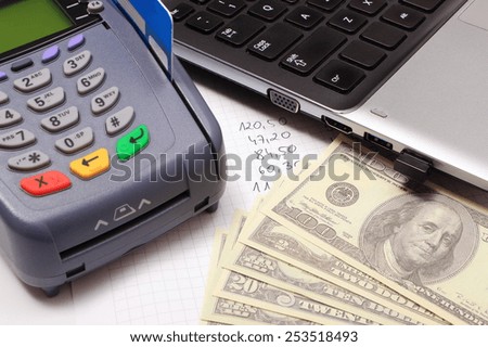 Payment terminal with credit card, money, laptop and financial calculations, credit card reader, finance concept