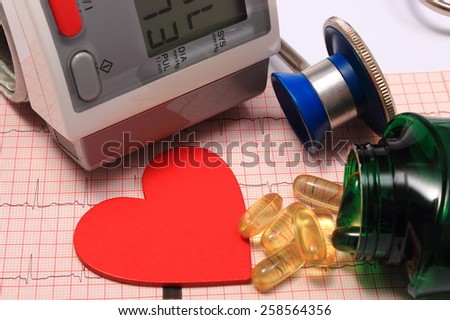 Medical stethoscope, instrument for measuring blood pressure, red heart shape and tablets on electrocardiogram graph, ekg heart rhythm, medicine concept
