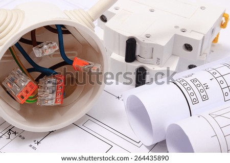 Copper wire connections in electrical box, rolls of electrical diagrams and electric fuse on construction drawing of house, accessories for engineering work, energy concept