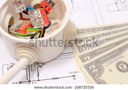 Copper wire connections in electrical box and money on construction drawing of house, concept for engineering and energy savings