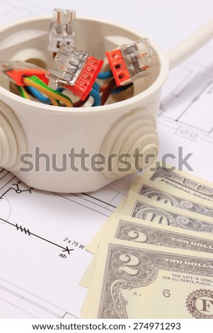 Copper wire connections in electrical box and money on construction drawing of house, concept for engineering and energy savings