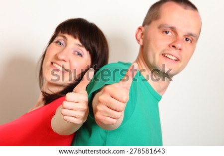 Smiling woman and man showing thumbs up, showing positive emotions, approval of offer or situation, face expression and human emotion