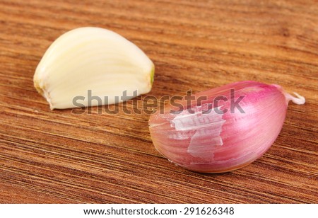 Cloves garlic on wooden surface, healthy food and nutrition