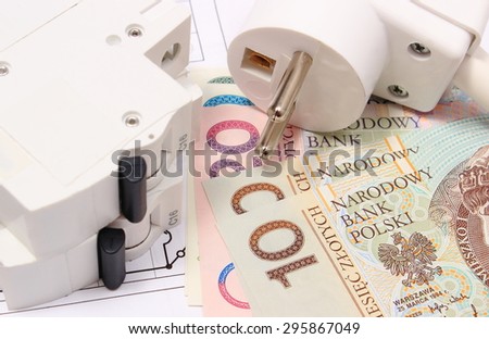 Electric fuse and plug with money on electrical construction drawing of house, accessories for engineering work, concept for energy saving
