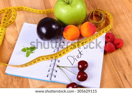 Fresh fruits and tape measure with notebook for writing notes, concept of slimming, diet and healthy nutrition