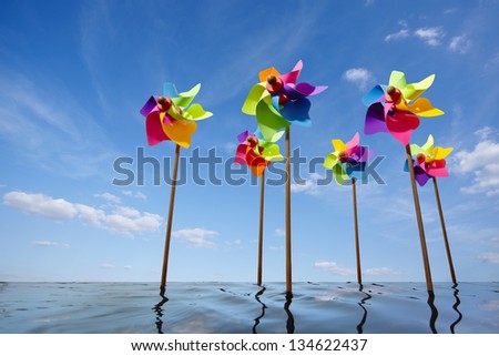 Toy windmill concept of green energy wind farm at sea