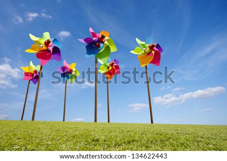 Toy windmill concept of green energy wind farm in field