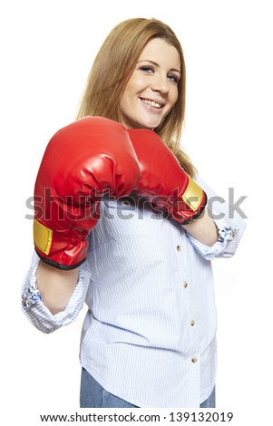 Young woman wearing boxing gloves smiling on white background