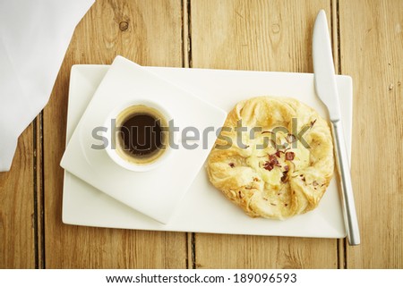 Custard crown pastry on white dish and wooden table top
