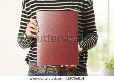 Female hands holding book with empty copy space. Student education concept
