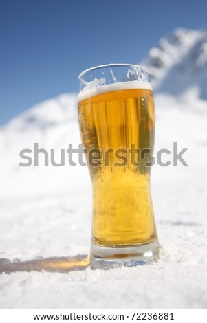 Beer glass over Alps in the snow