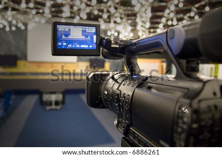 Digital video camera shoots meeting - 3CCD Camcorder recording in TV studio
