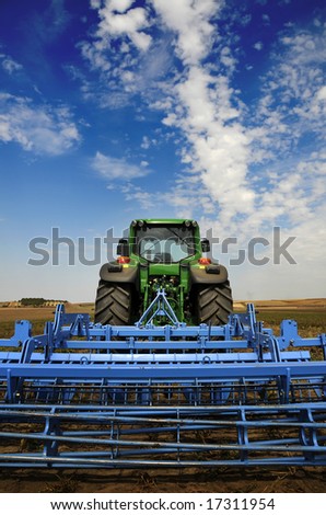 The Tractor - modern farm equipment in field