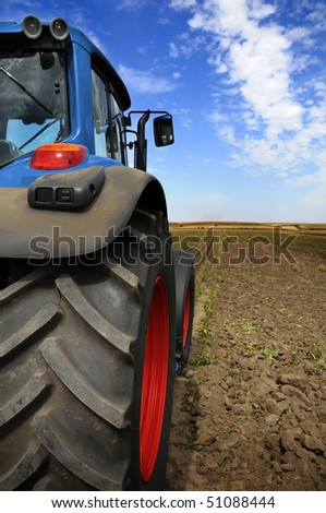 The Tractor - modern farm equipment in field