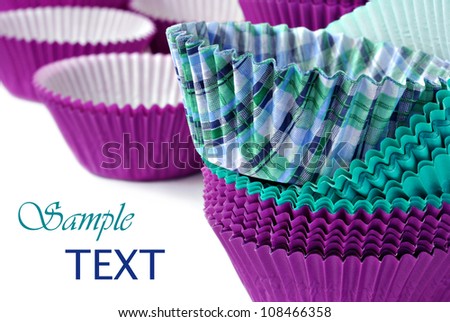 Colorful cupcake wrappers on white background with copy space.  Macro with shallow dof.