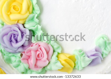Bakery cake with copy space.  Close-up of pastel colored roses on white frosting.