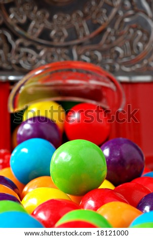 Colorful bubble gum spilling from a gumball machine.  Macro with extremely shallow dof.  Selective focus on green gumball.