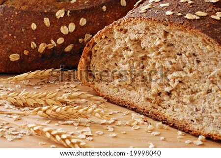 Freshly baked whole grain wheat bread with wheat spikes.  Macro with shallow dof.