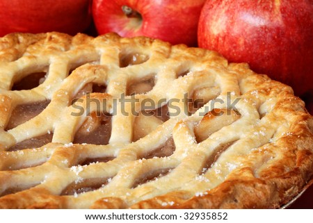 Freshly baked apple pie with apples in the background.  Macro with shallow dof.