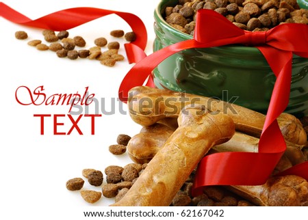 Still life of dog food and healthy treats with red ribbon on white background with copy space.  Macro with shallow dof.
