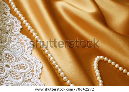 stock photo Beautiful cultured pearls and embroidered lace on elegant gold 