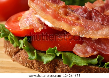 Freshly prepared bacon, lettuce, and tomato sandwich on whole grain wheat toast.  Macro with extremely shallow dof.